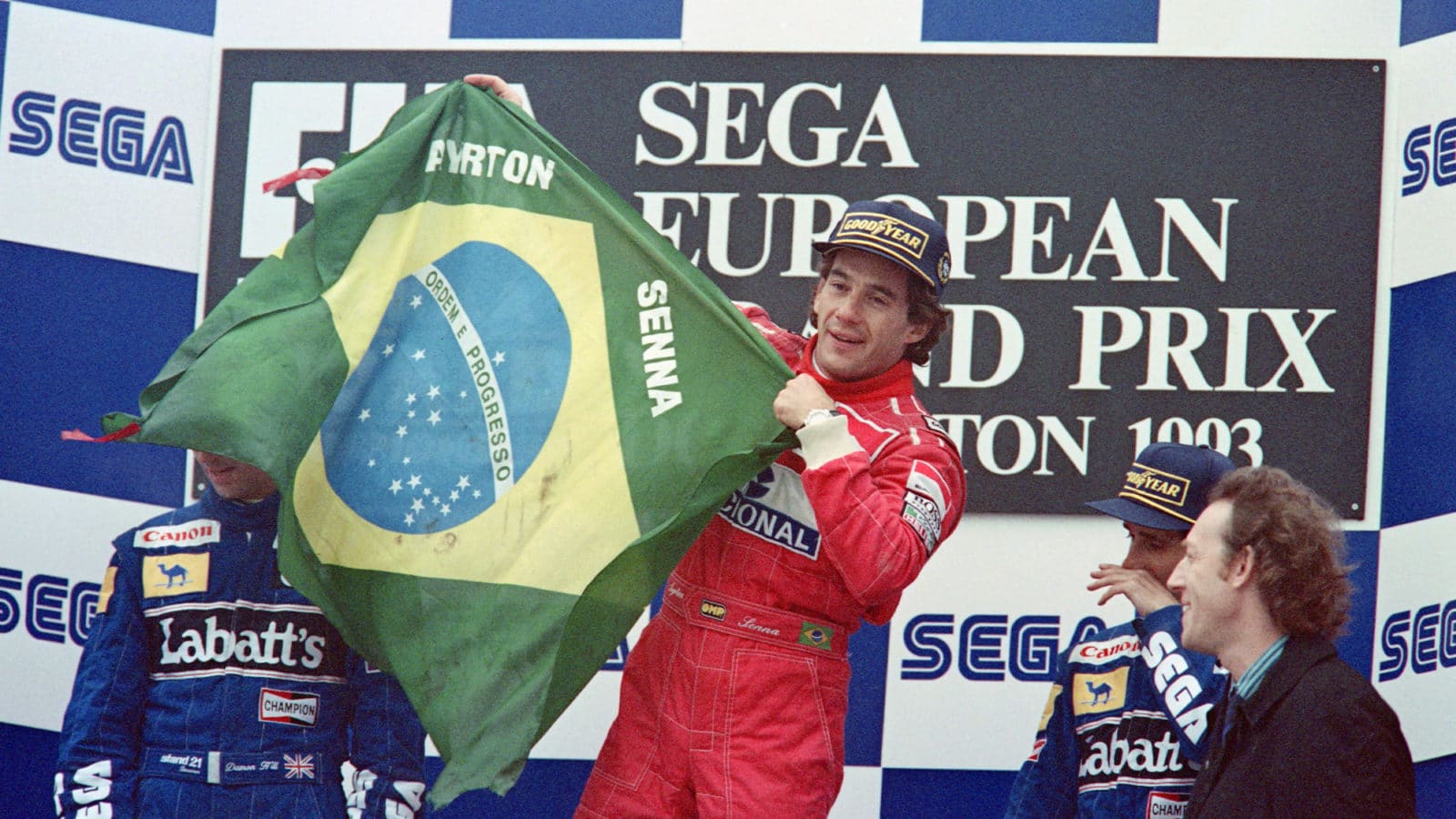 Ayrton Senna holds Brazilian flag on the podium in 1993 Donington European GP