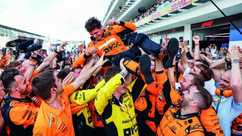 McLaren team lift Lando Norris in the air after his debut F1 win at the 2024 Miami Grand Prix