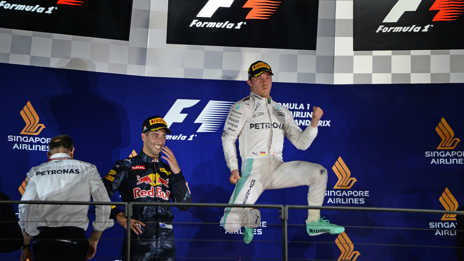 Nico Rosberg jumps up on the podium after winning the 2016 Singapore Grand Prix