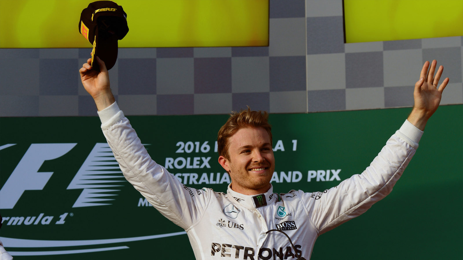 Nico Rosberg with arms raised on Melbourne podium after winning 2016 F1 Australian Grand Prix