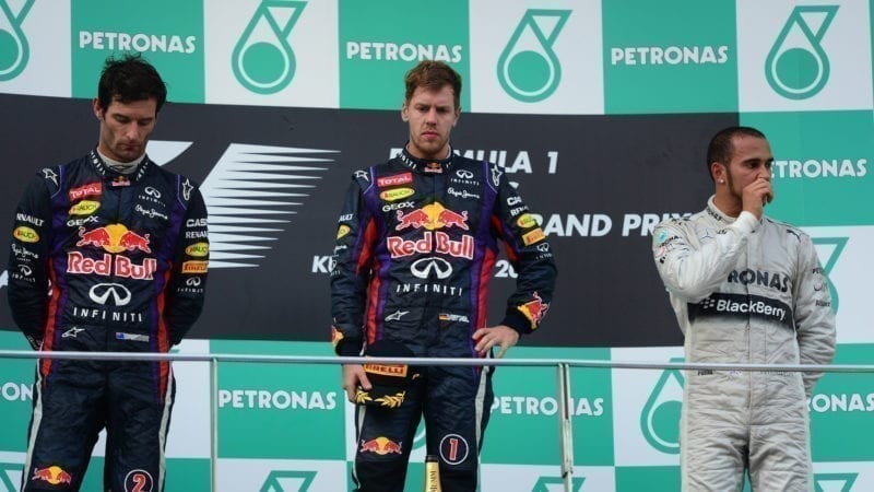 Sebastian Vettel Mark Webber and Lewis Hamilton on the podium at the 2013 Malaysian Grand Prix