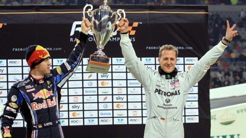Sebastian Vettel and Michael Schumacher with trophy from 2010 Race of Champions