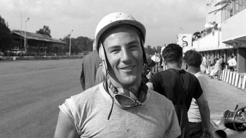 Stirling Moss smiles for the camera at the 1955 Italian Grand Prix