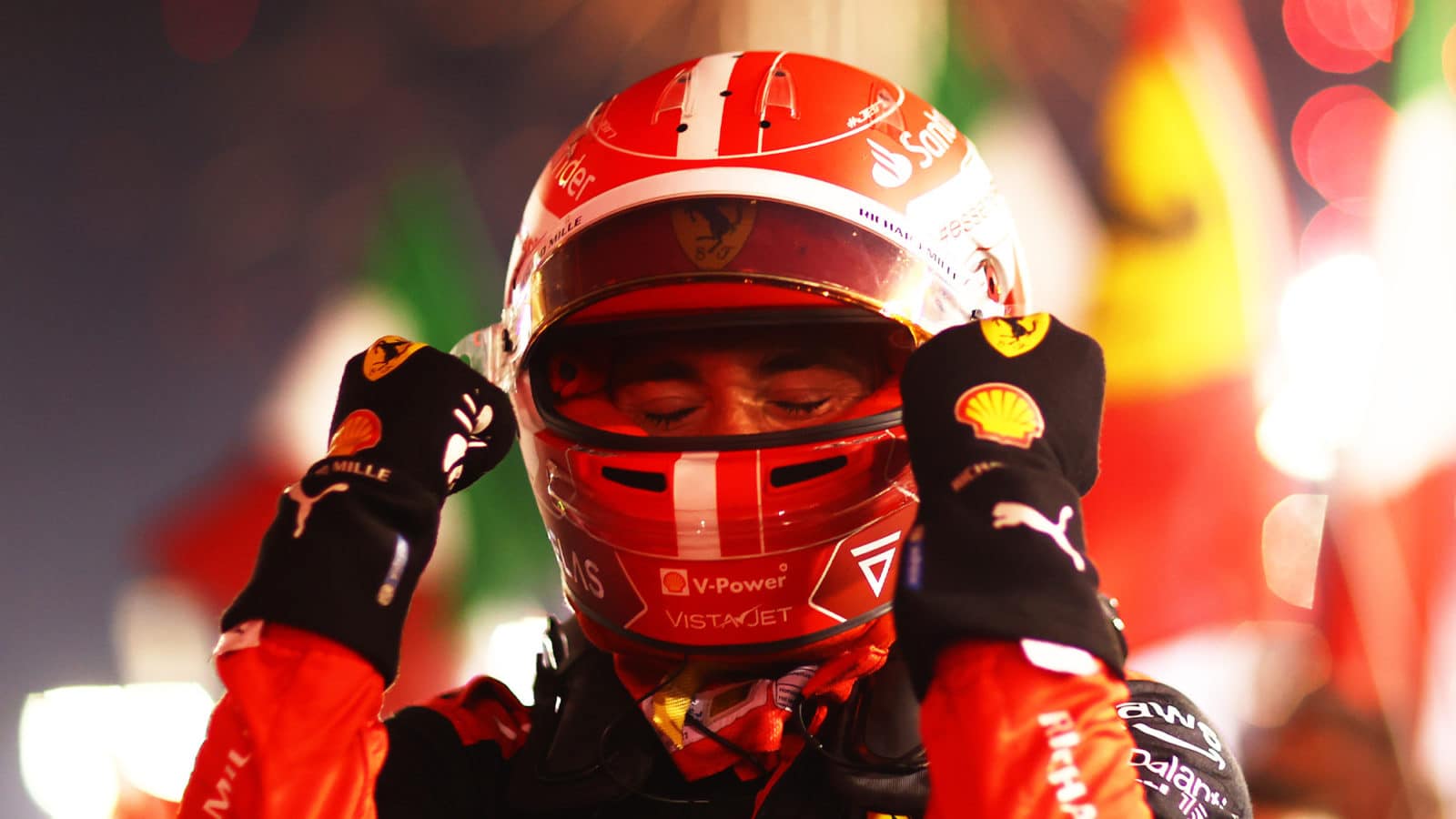 Charles Leclerc throws up his arms after winning the 2022 F1 Bahrain Grand Prix