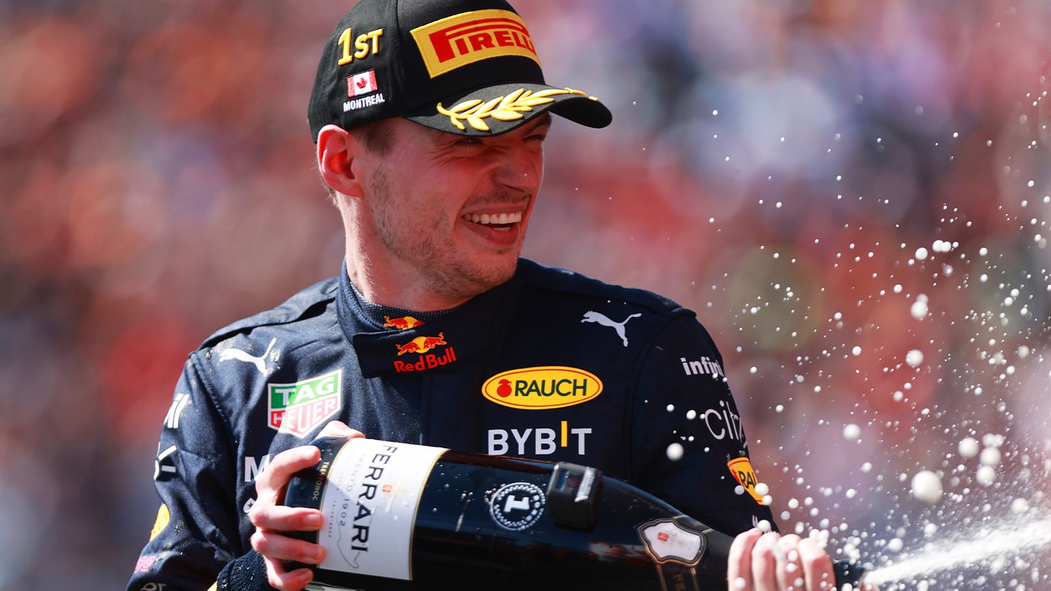 Max Verstappen sprays champagne on the podium after winning the 2022 Canadian Grand Prix