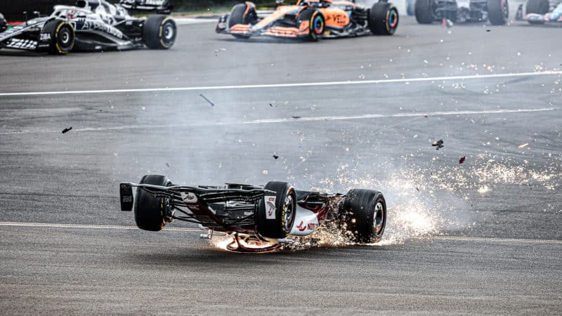 Sparks fly as Alfa Romeo of Zhou Guanyu slides upside down at the 2022 British Grand Prix