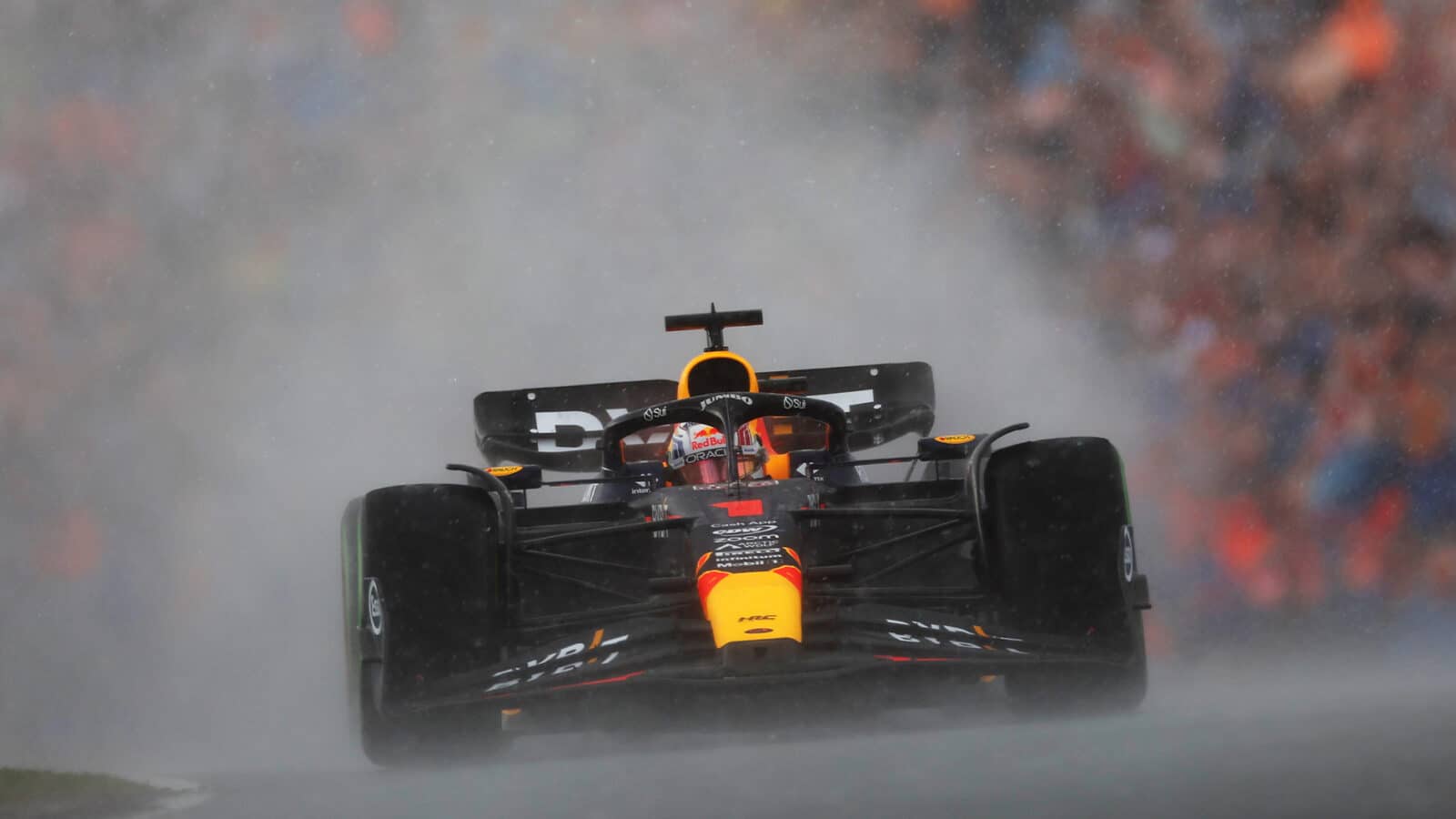Max Verstappen drives through rain in a cloud of spray at 2023 Dutch GP