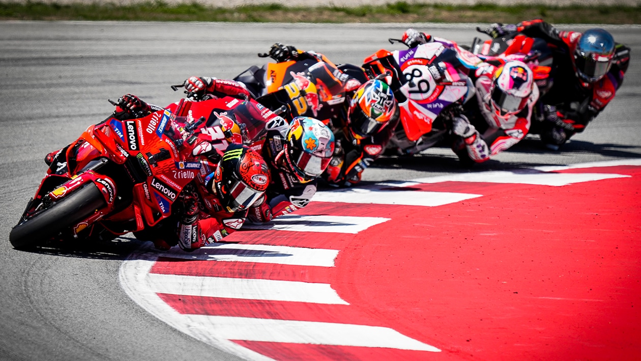 Pecco Bagnaia leads train of riders through corner at 2024 MotoGP Catalan GP