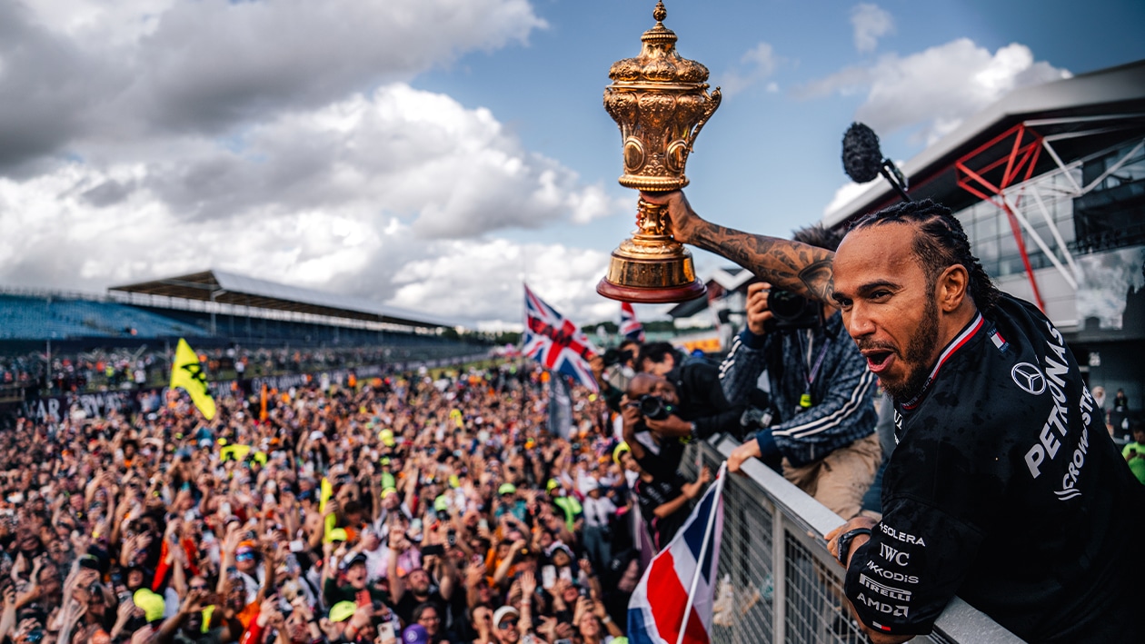 Lewis Hamilton holds British GP trophy as he waves to crowd at 2024 F1 race