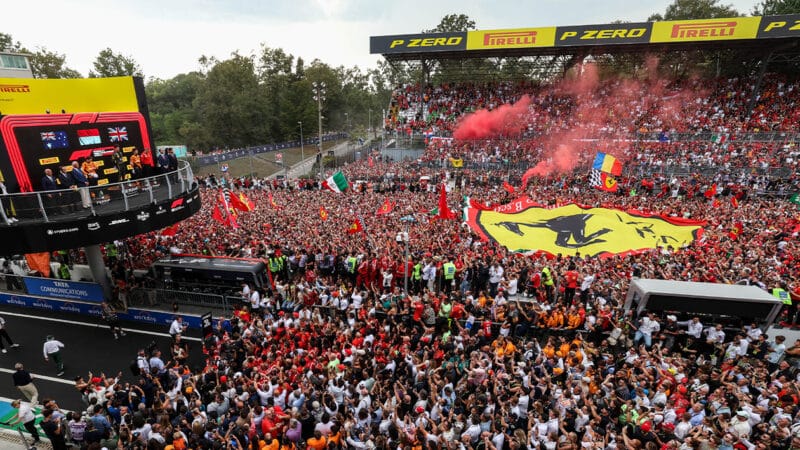 Charles Leclerc on the Monza podium in front of massed ferrari fans at the 2024 F1 Italian Grand Prix