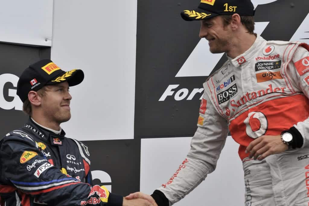 Jenson Button and Sebastian Vettel shake hands on the podium after the 2011 F1 canadian grand prix