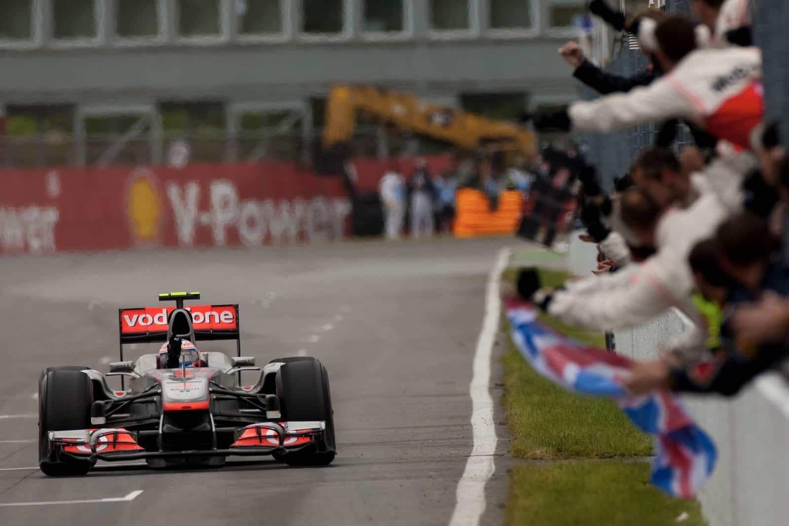 Jenson Button raises his hand in victory after winning the 2011 canadian grand prix