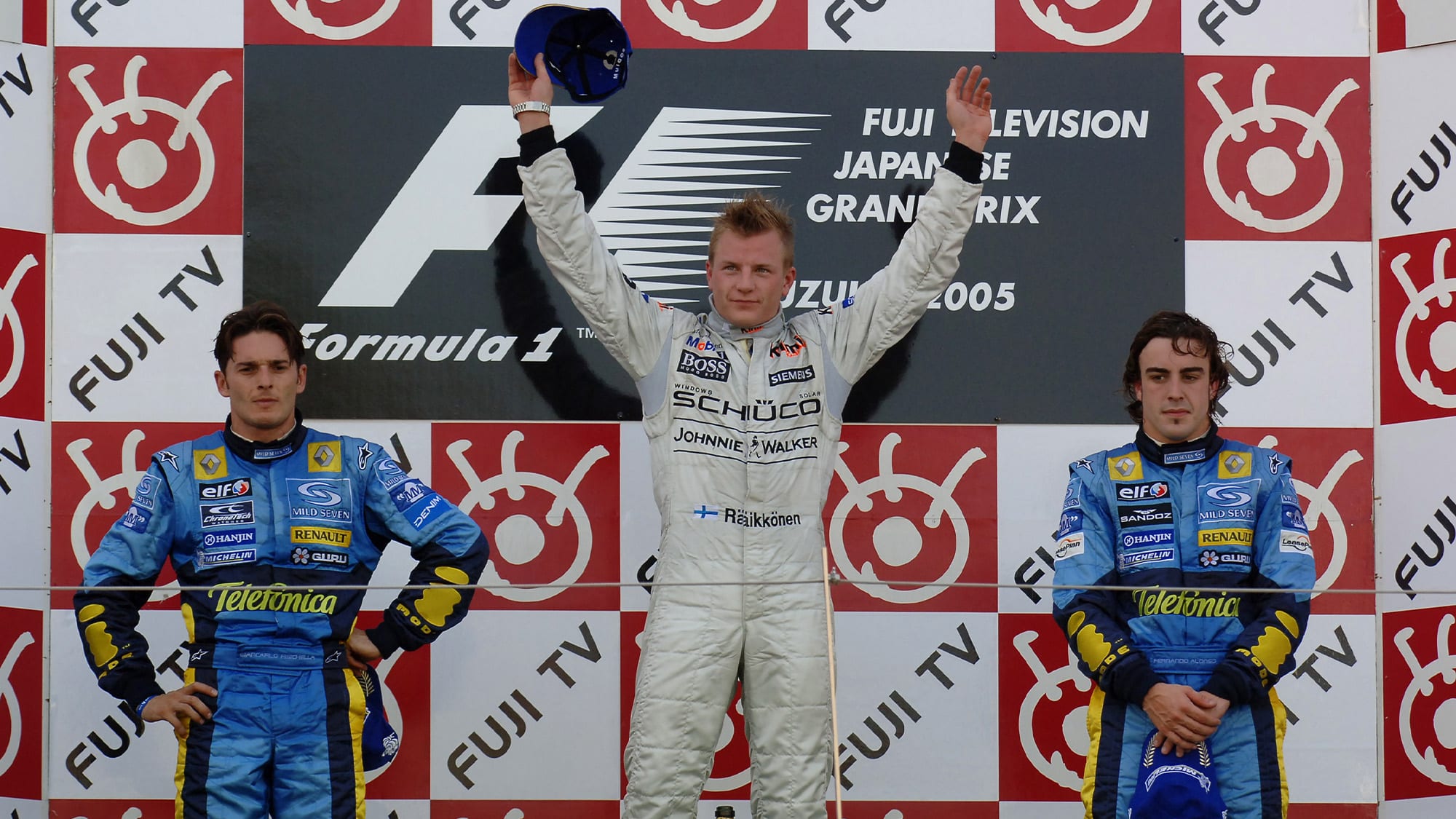 Kimi Raikkonen on the podium alongside Giancarlo Fisichella and Fernando Alonso after winning the 2005 F1 Japanese Grand prix at Suzuka