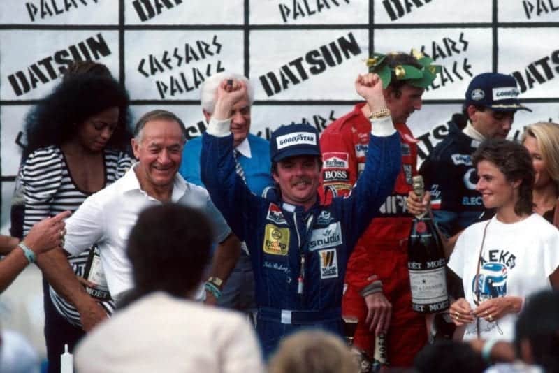 Keke Rosberg is crowned World Champion after finishing fifth in the final race of the season. To his right are John Watson and Michele Alboreto who finished second and first respectively. Diana Ross (far left) presented the trophies.
