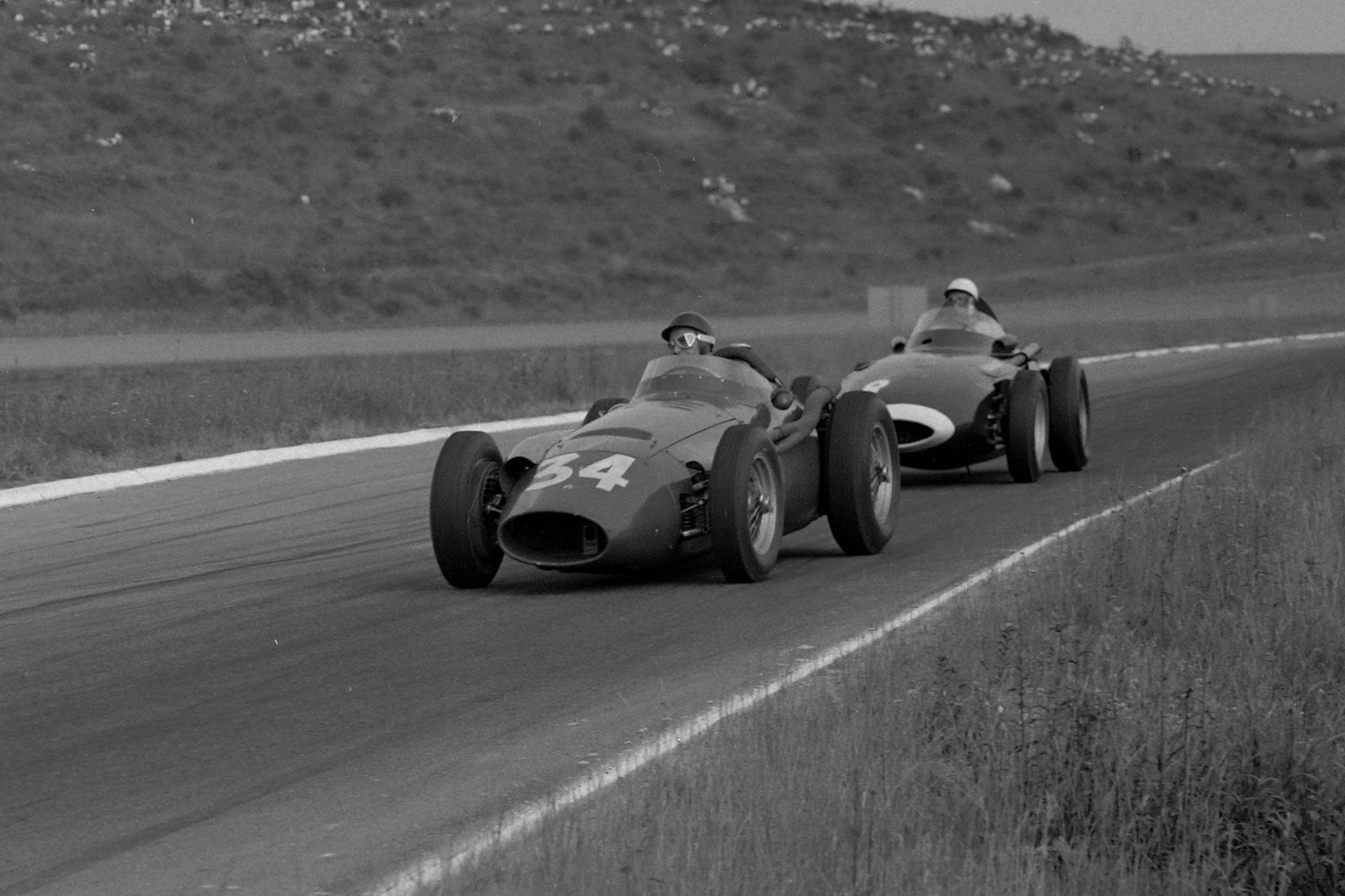Juan Manuel Fangio in his Maserati 250F leads Stirling Moss in his Vanwall.