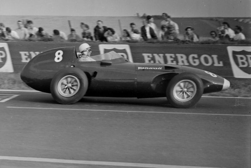 Stirling Moss blast by in a Vanwall.