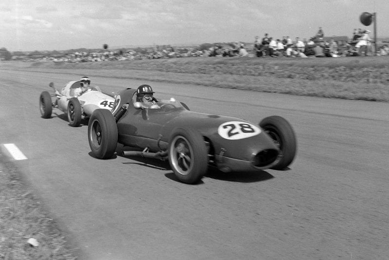 Graham Hill driving a Lotus 16 Climax, leads Chris Bristow in a Cooper T51 Borgward.