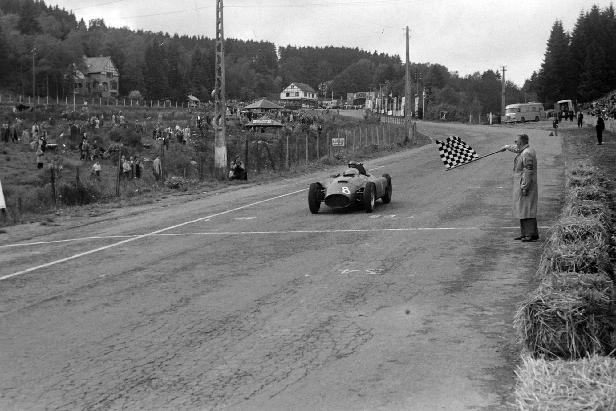 Peter Collins crosses the line to win