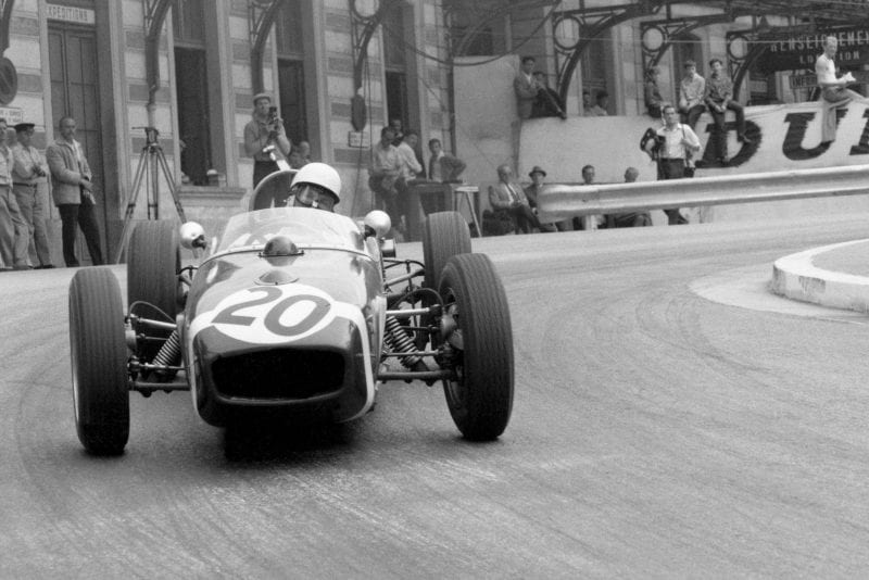 Stirling Moss pushing his Lotus 18-Climax.