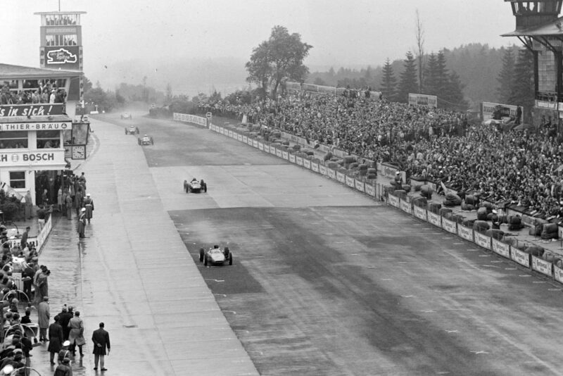 Dan Gurney leads Graham Hill on the pit straight