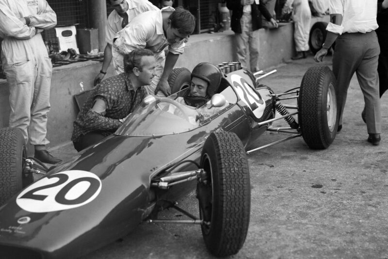 Jim Clark and Colin Chapman converse in the pitlane