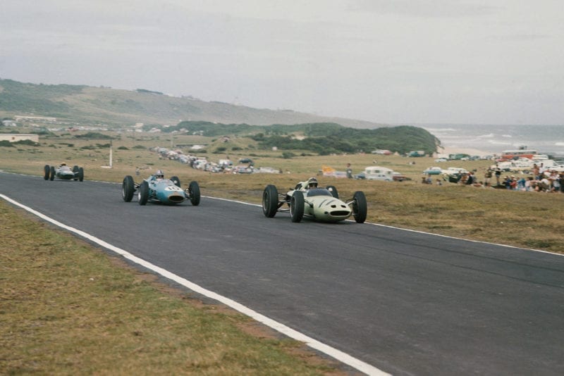 Innes Ireland (Lotus 24 Climax) leads Jack Brabham (Brabham BT3 Climax) and Trevor Taylor (Lotus 25 Climax).