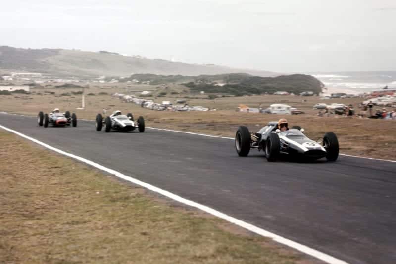 Tony Maggs leads Bruce McLaren (both Cooper T60 Climax's) and John Surtees (Lola Mk4 Climax). McLaren and Maggs finished in 2nd and 3rd positions respectively.