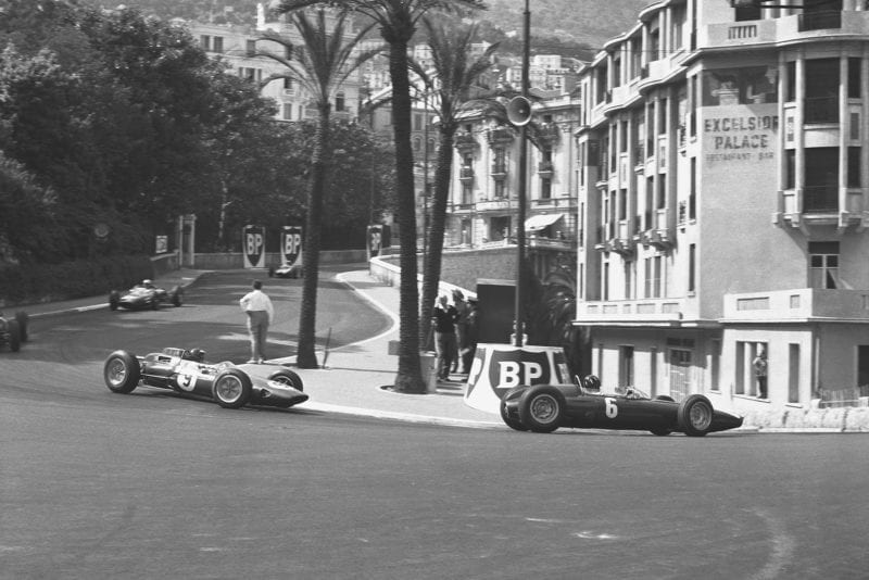 Graham Hill (BRM P57) leads Jim Clark (Lotus 25 Climax) in Station Hairpin.