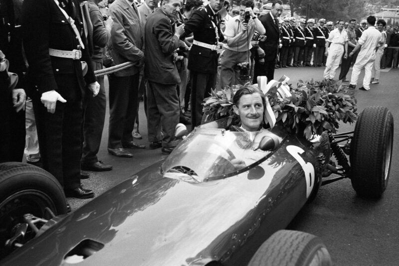 Graham Hill, BRM P57, celebrates victory.