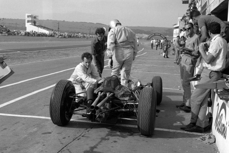 Jack Brabham gets out of his Brabham BT7 Climax.