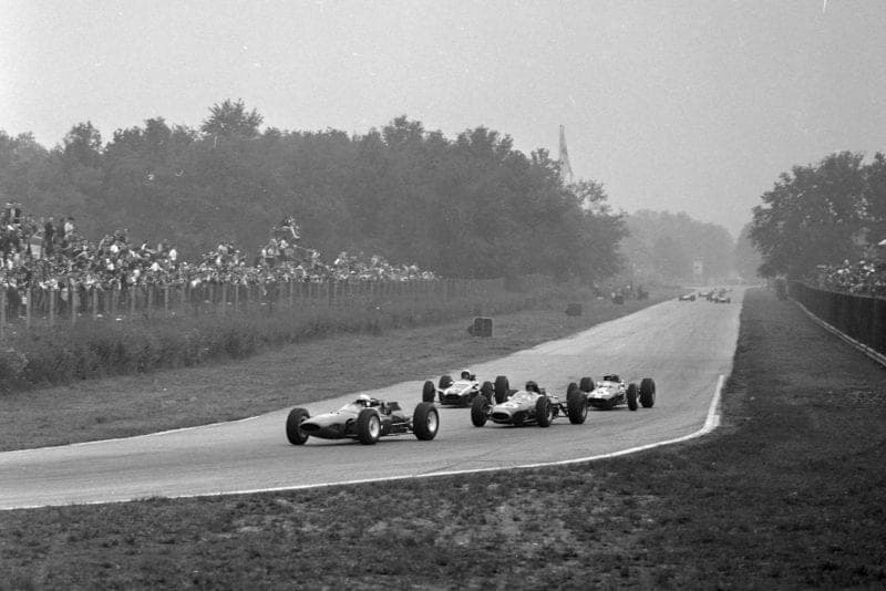 John Surtees, Ferrari 158, leads Dan Gurney, Brabham BT7 Climax, Bruce McLaren, Cooper T73 Climax, and Jim Clark, Lotus 33-Climax
