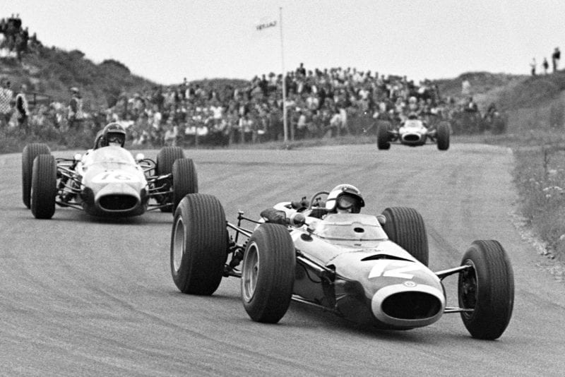 Jackie Stewart, BRM P261, leads Dan Gurney, Brabham BT11 Climax.
