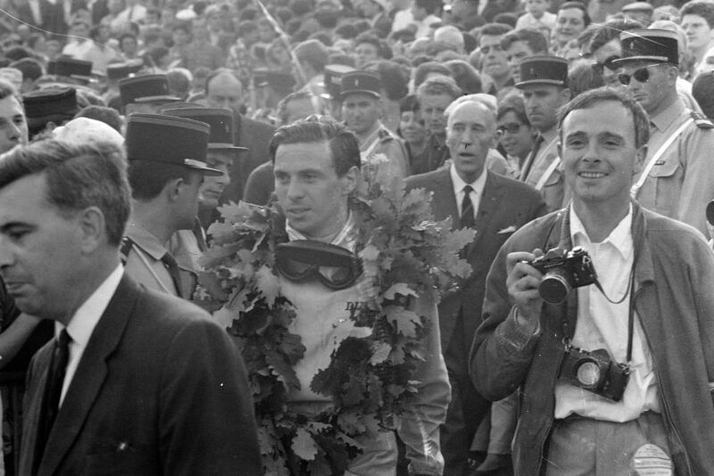 Jim Clark, 1st position, with his race winner's wreath.