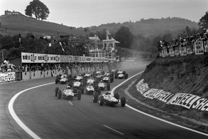 Jim Clark, Lotus 25 Climax, leads Lorenzo Bandini, Ferrari 1512, Jackie Stewart, BRM P261, Dan Gurney, Brabham BT11 Climax, John Surtees, Ferrari 158, and the rest of the field at the start of the race.