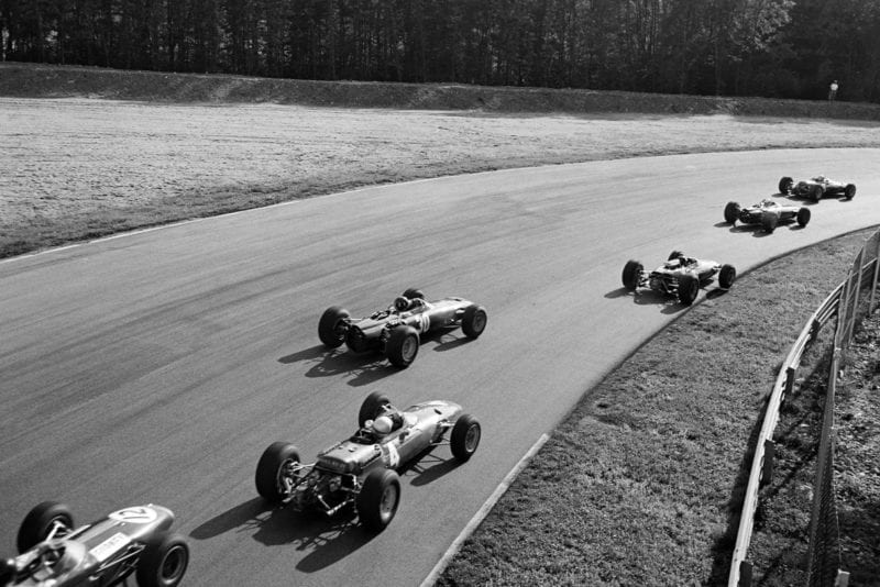Graham Hill, BRM P261, and Lorenzo Bandini, Ferrari 1512, in the pack.