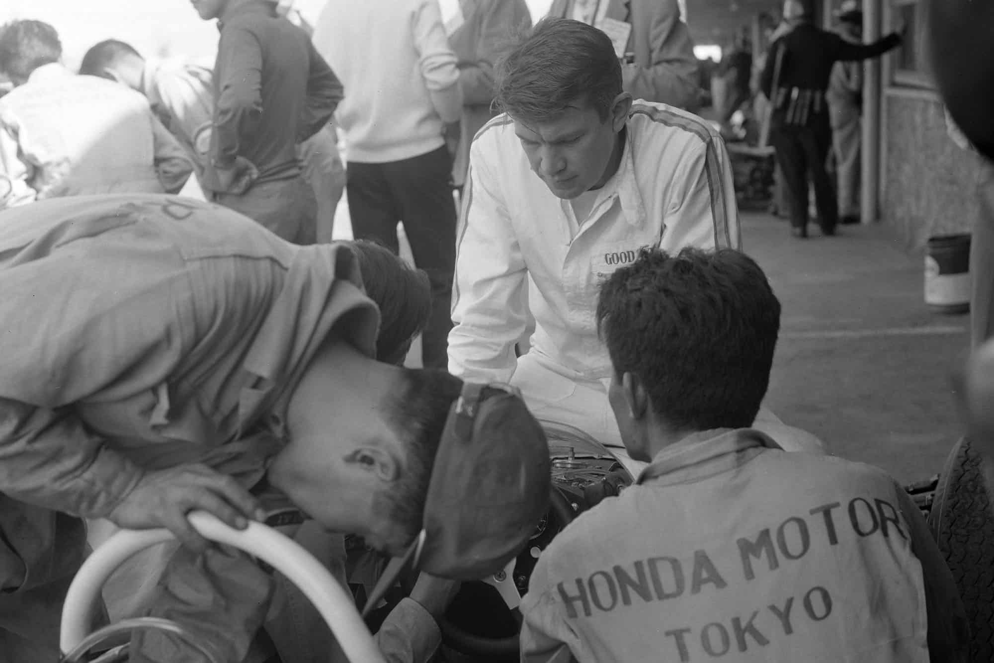 Ronnie Bucknum watches on as mechanics work on his Honda RA272.