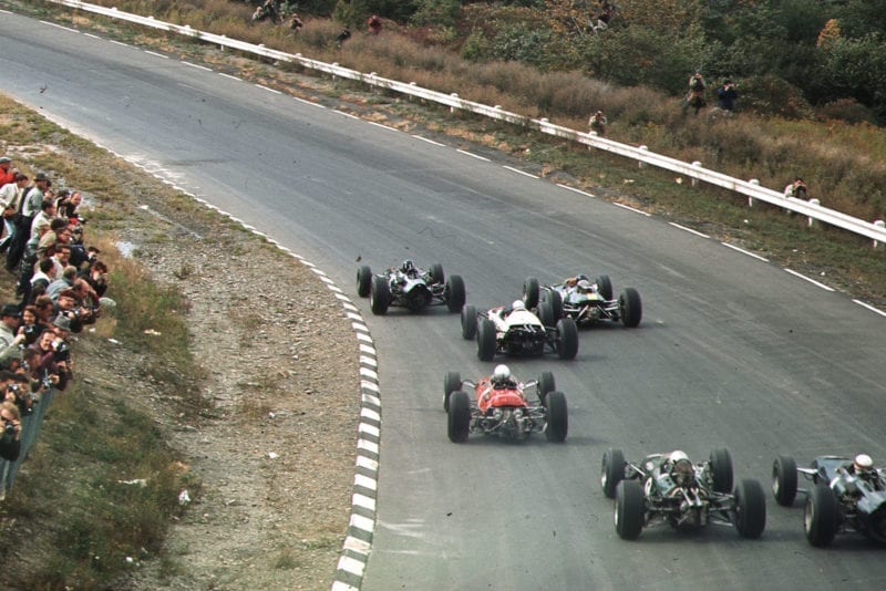 Graham Hill (BRM P261) leads Jim Clark (Lotus 33 Climax) and the field at the start.