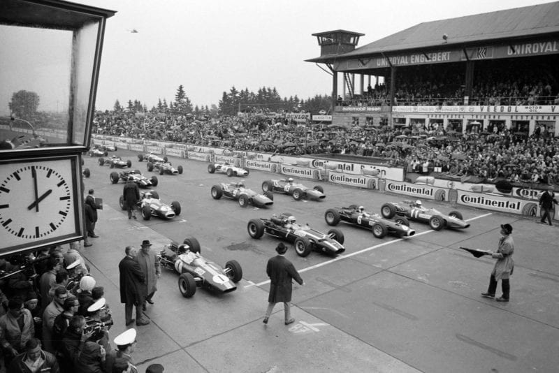 Pole sitter Jim Clark, Lotus 33 Climax waits alongside John Surtees, Cooper T81 Maserati, Jackie Stewart, BRM P261 and Ludovico Scarfiotti, Ferrari 246 on the front row of the grid.