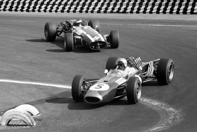 Second placed Jack Brabham (AUS) Brabham BT20 leads Jochen Rindt (AUT) who retired on lap 32 with a broken suspension.