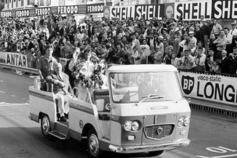 Jackie Stewart, BRM P261, 1st position, waves to the crowd on his victory parade.