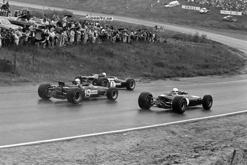 Jack Brabham, Brabham BT24 Repco, leads Mike Fisher, Lotus 33 BRM, and Bruce McLaren, McLaren M5A BRM.