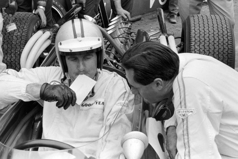 Denny Hulme and Jack Brabham, confer during qualifying.