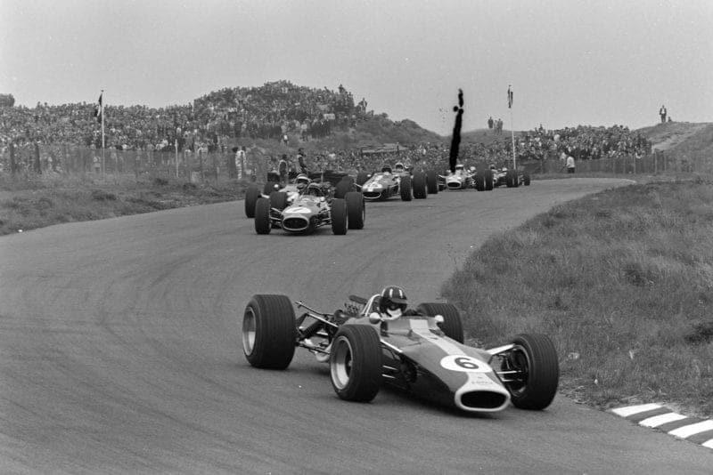Graham Hill, Lotus 49 Ford leads Jack Brabham, Brabham BT19 Repco, on the opening lap.