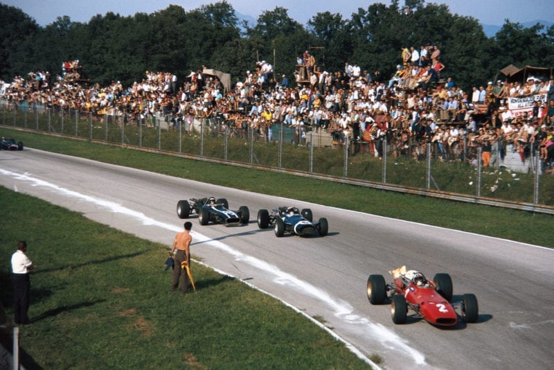 Chris Amon, Ferrari 312, leads Jo Siffert, Cooper T81 Maserati, and Jochen Rindt, Cooper T86 Maserati, into Parabolica.