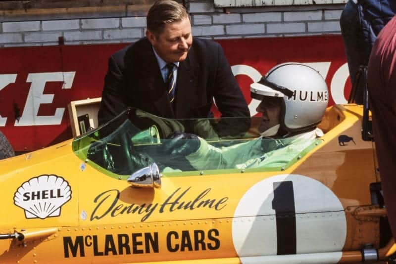 Denny Hulme, McLaren M7A Ford, in the pit lane.