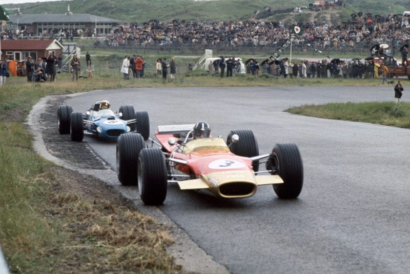 Graham Hill (Lotus 49B-Ford), 9th position, leads Jackie Stewart (Matra MS10-Ford), 1st position, action.