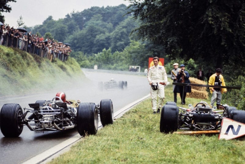 Jo Siffert, Lotus 49 Ford, pulls to the side of the track alongside retired Graham Hill, Lotus 49B Ford.