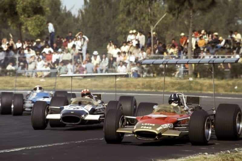 Graham Hill (Lotus) leads Jo Siffert (Lotus) and Jackie Stewart (Matra).