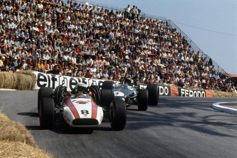 John Surtees (Honda RA301), retired, leads Jochen Rindt (Brabham BT24-Repco), retired, action.
