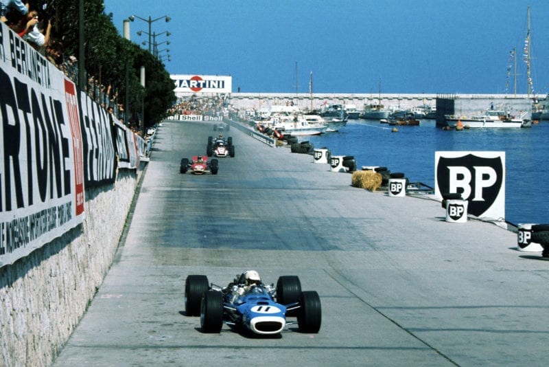 Johnny Servoz-Gavin (FRA), Matra Ford MS10, retired on lap 3 with halfshaft failure. Eventual race winner Graham Hill (GBR), Lotus Ford 49B, is in the background.